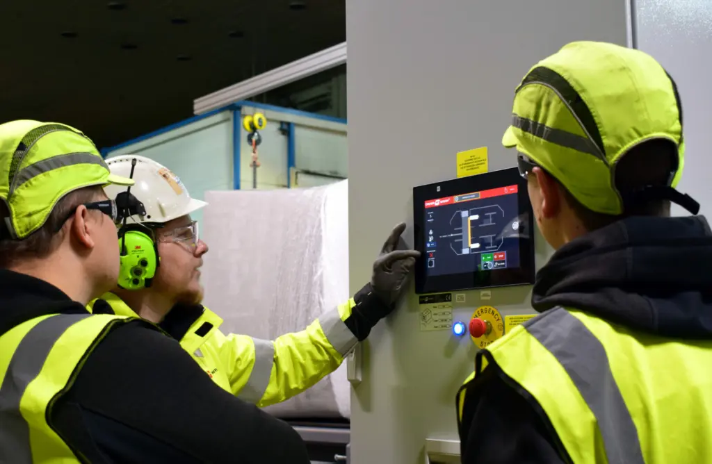 On Imagine: automation team looking at machine settings on a screen